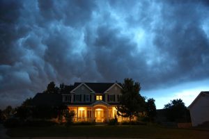 House in bad summer thunderstorm - still lit